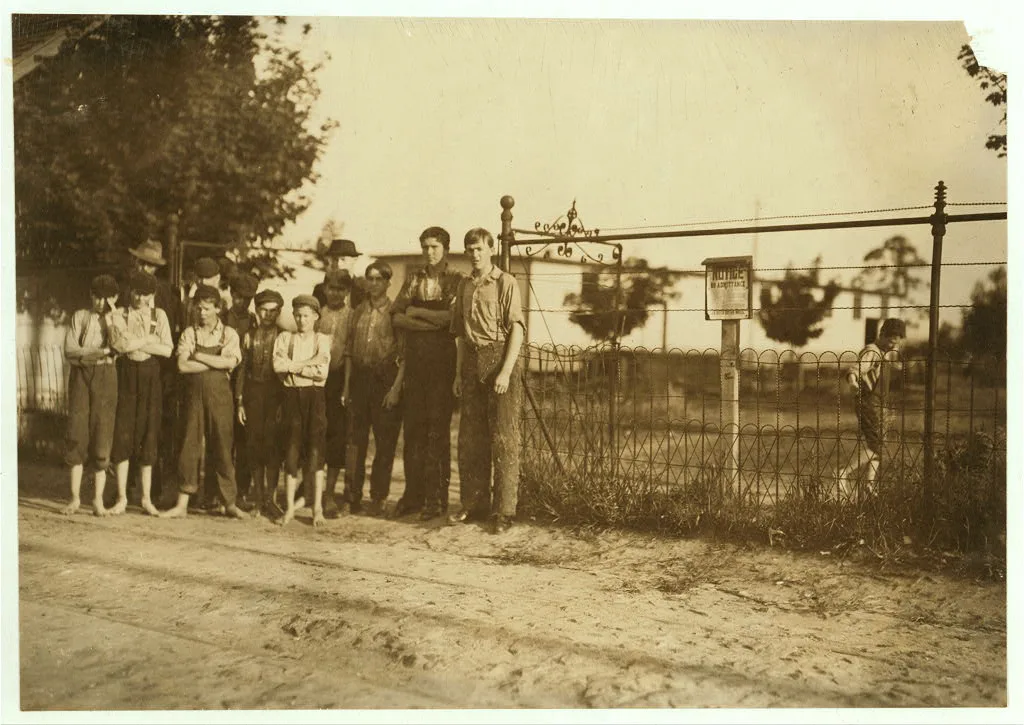 Boys at the gate, and one running off, work in Schoolfield Mills,…, Virginia, 1911