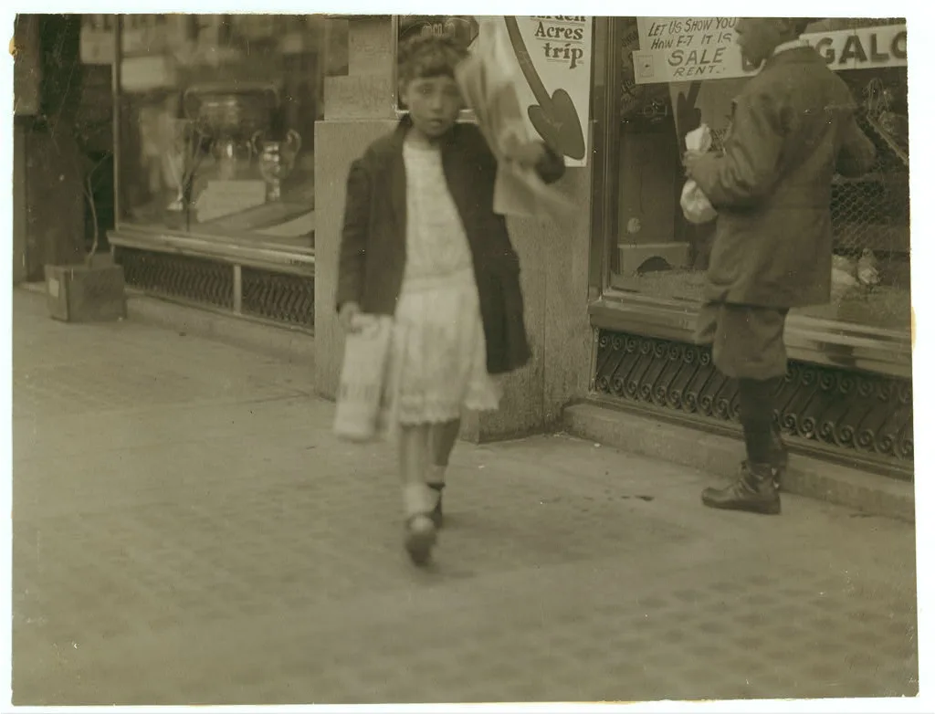 Newsgirl about 11 years old, with a single paper making a begging and…, California, 1915