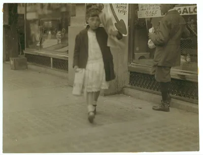 Newsgirl about 11 years old, with a single paper making a begging and…, California, 1915