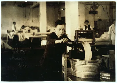 Edward McGurin, 14 years old. Wringing curtains at Boutwell,…, Massachusetts, 1917