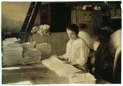 15-year old girl folding towels in Bonanno Laundry.  Location:…, Massachusetts, 1917