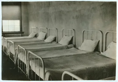 Crowded dormitory (one wall) in Training School for Deaf Mutes. See…, Oklahoma, 1917