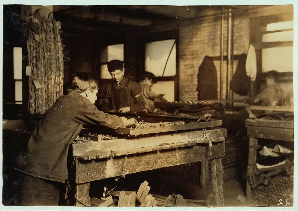 Boys "linking" bed-springs. 14 and 15 years old.  Location: Boston,…, Massachusetts, 1917
