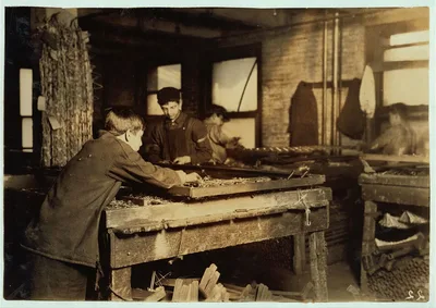 Boys "linking" bed-springs. 14 and 15 years old.  Location: Boston,…, Massachusetts, 1917