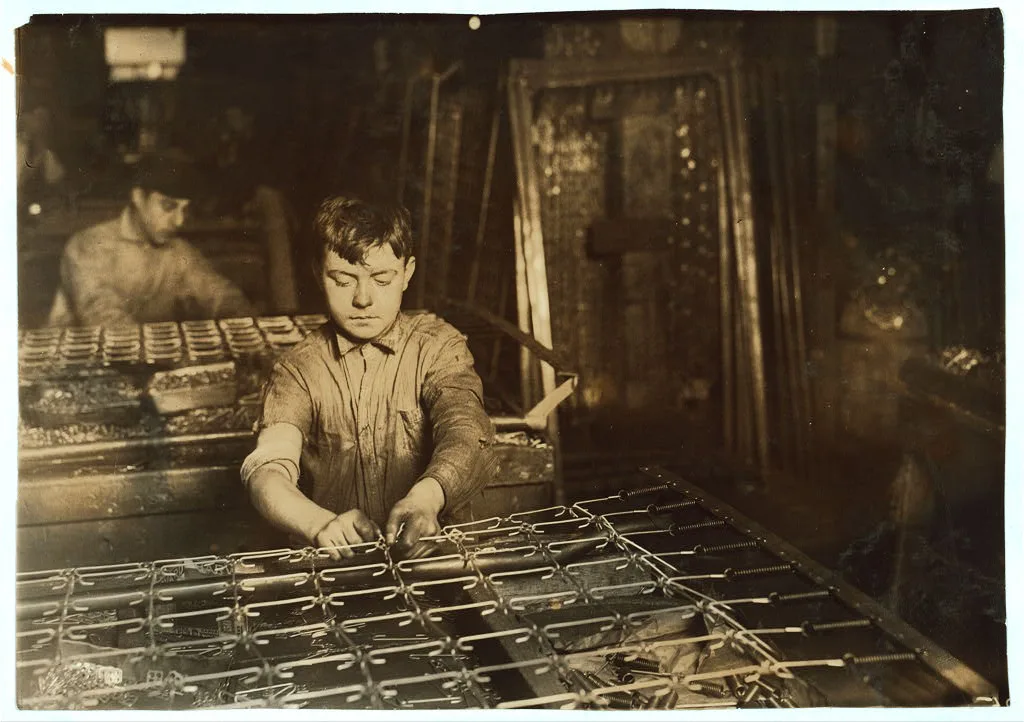 [Boys "linking" bed-springs. 14 and 15 years old.]  Location:…, Massachusetts, 1917
